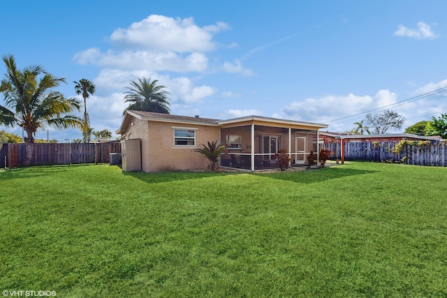 back of house featuring a lawn, central air condition unit, and a sunroom