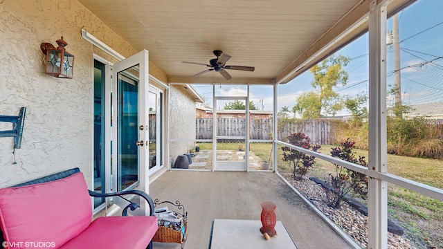 sunroom / solarium featuring ceiling fan and wood ceiling