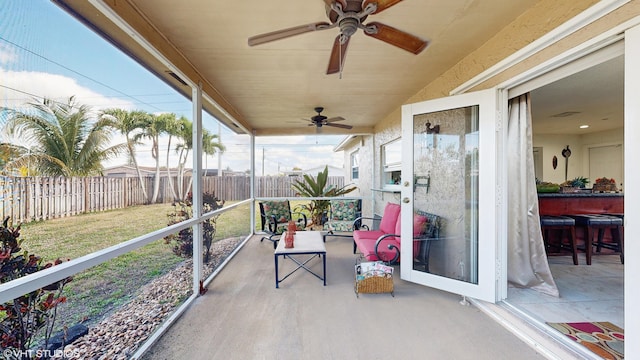 sunroom / solarium with ceiling fan and a healthy amount of sunlight