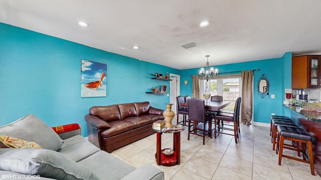 living room with light tile patterned floors and a notable chandelier