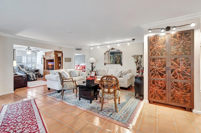 tiled living room with ceiling fan, crown molding, and rail lighting