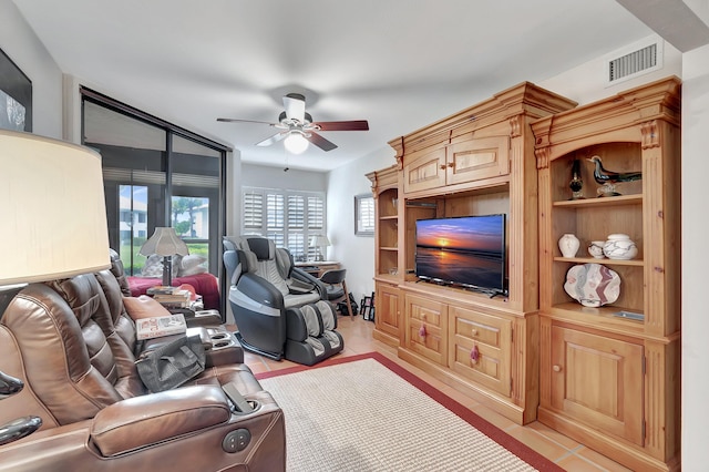 living room with ceiling fan and light tile patterned flooring