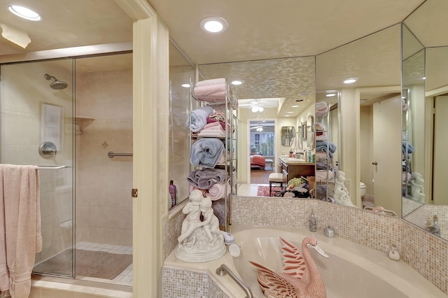 bathroom featuring ceiling fan, independent shower and bath, and toilet