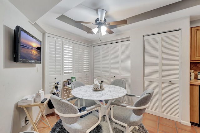 tiled dining area with ceiling fan