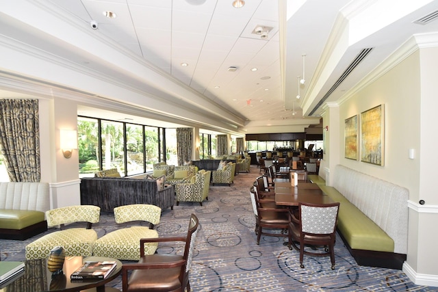 carpeted dining space with ornamental molding