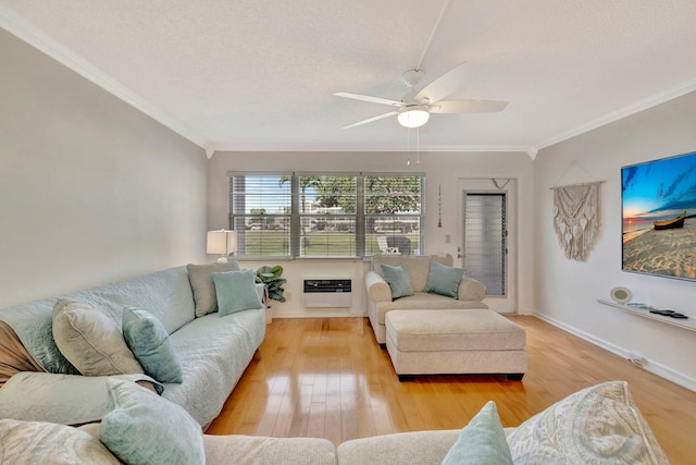 living room featuring heating unit, crown molding, light hardwood / wood-style floors, and a textured ceiling