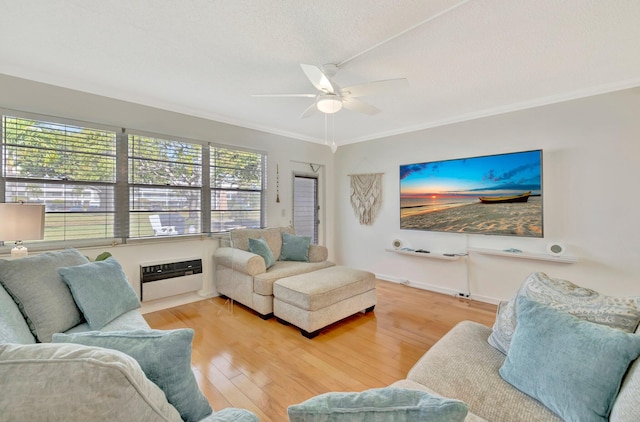 living room featuring hardwood / wood-style flooring, ceiling fan, ornamental molding, a textured ceiling, and heating unit