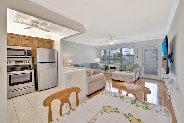 living room featuring light hardwood / wood-style flooring, ceiling fan, and ornamental molding