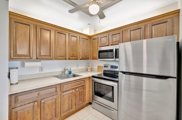 kitchen featuring crown molding, sink, ceiling fan, light tile patterned floors, and appliances with stainless steel finishes