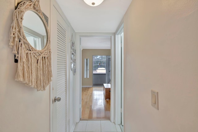 corridor featuring light tile patterned floors