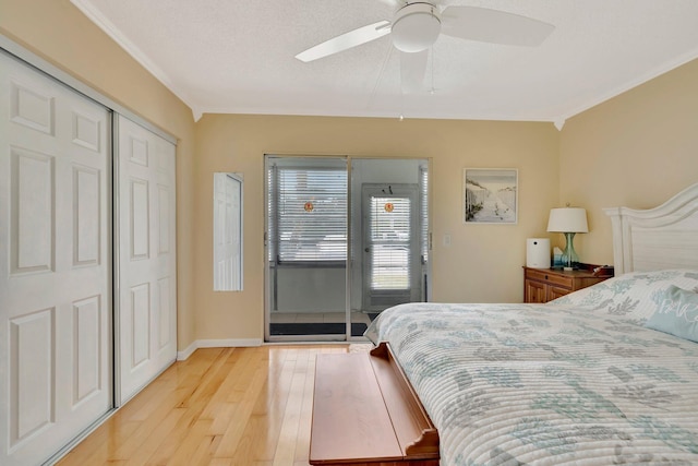 bedroom with access to outside, ceiling fan, light hardwood / wood-style flooring, and a textured ceiling