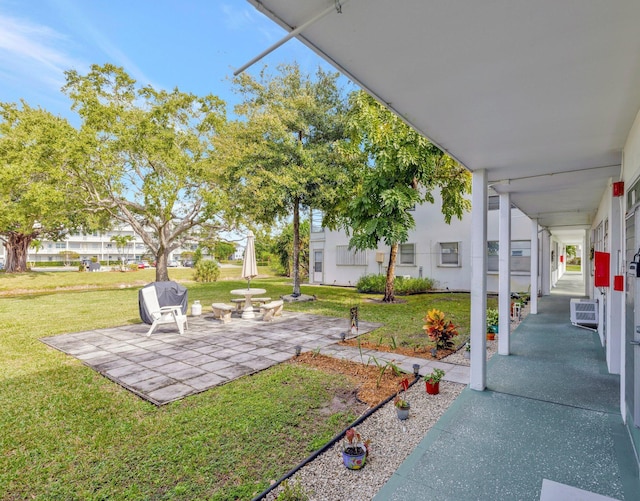 view of yard with a patio and an AC wall unit