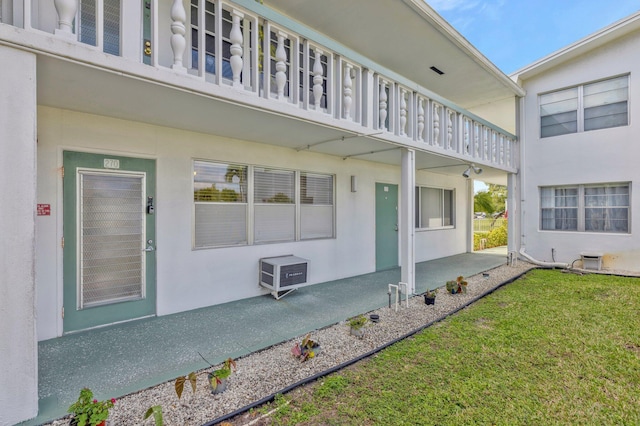 view of property exterior with a patio area and a lawn