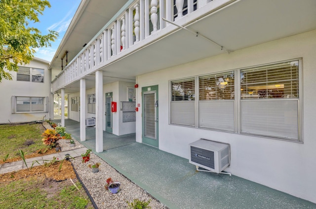 view of exterior entry with a balcony