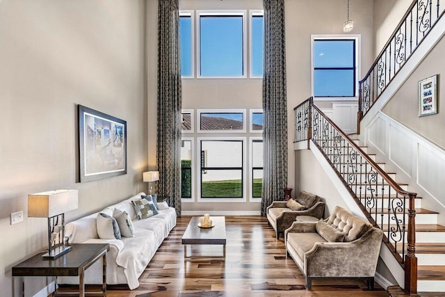 living room with hardwood / wood-style floors and a high ceiling