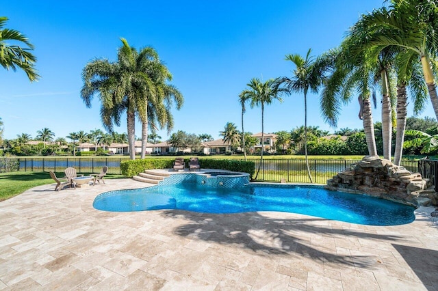 view of swimming pool with a patio area, an in ground hot tub, and a water view