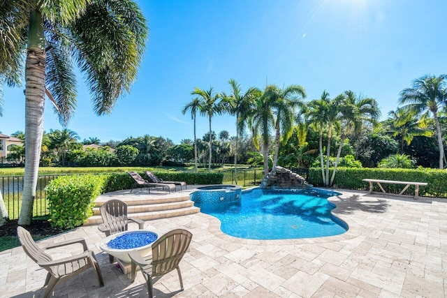 view of pool featuring an in ground hot tub and a patio