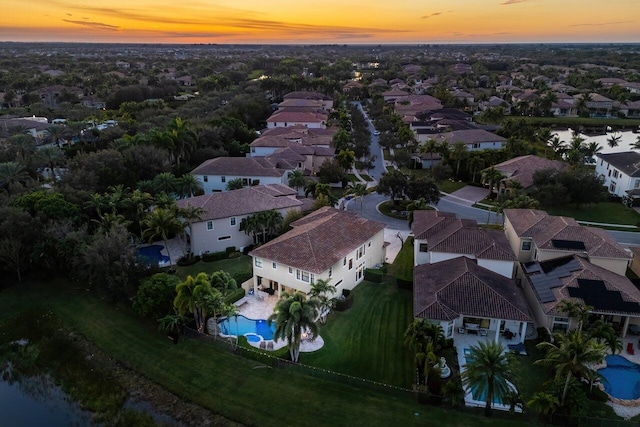 aerial view at dusk with a water view