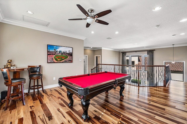 playroom featuring ceiling fan, ornamental molding, a textured ceiling, pool table, and light hardwood / wood-style floors