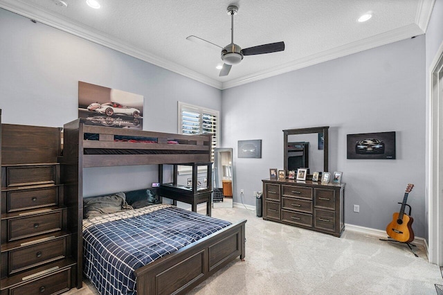 carpeted bedroom featuring ceiling fan, crown molding, and a textured ceiling