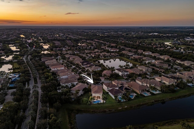 aerial view at dusk with a water view