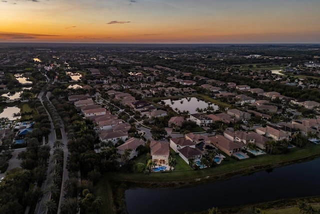 aerial view at dusk with a water view