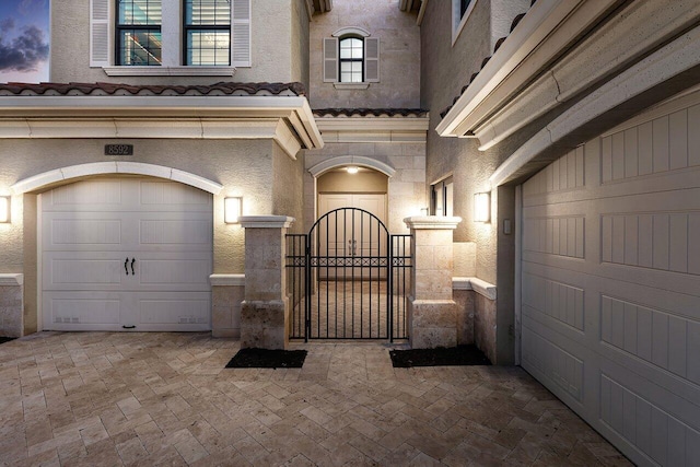 exterior entry at dusk with a garage