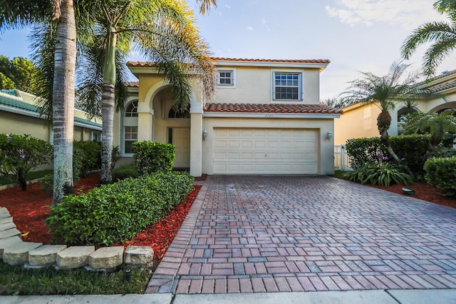 mediterranean / spanish-style home with a garage