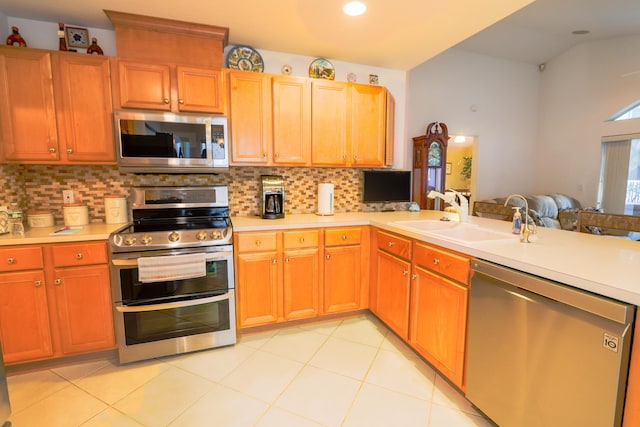 kitchen featuring light tile patterned flooring, sink, stainless steel appliances, and tasteful backsplash