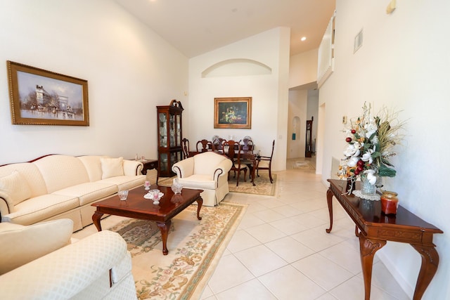 tiled living room featuring high vaulted ceiling