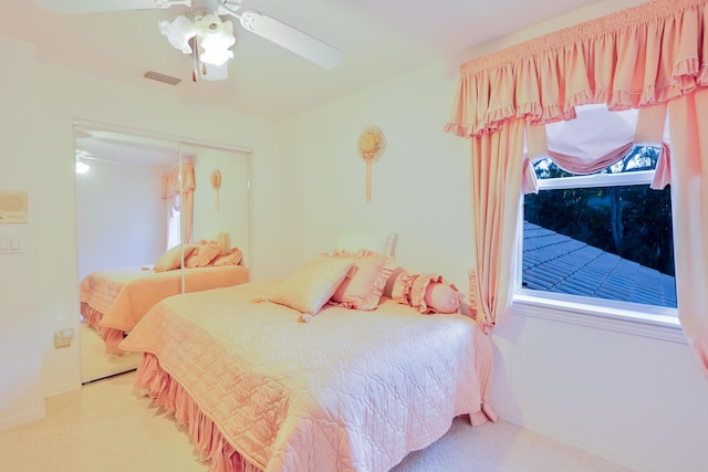 carpeted bedroom featuring ceiling fan and a closet