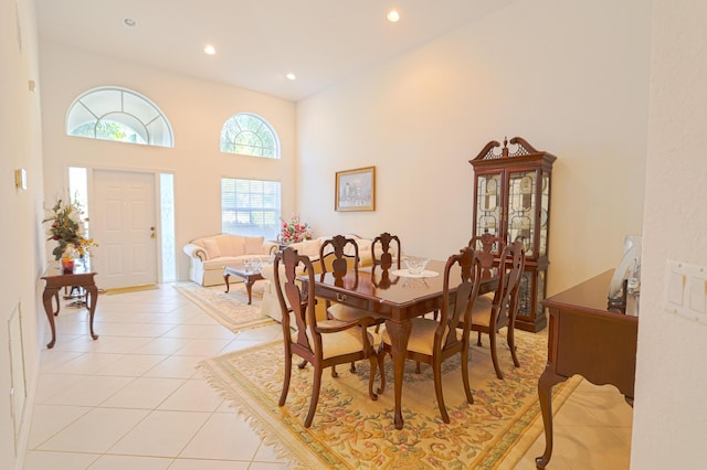 tiled dining room with a high ceiling