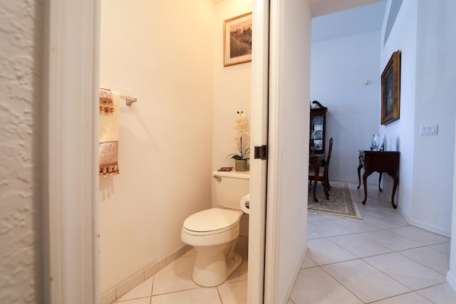 bathroom with tile patterned flooring and toilet