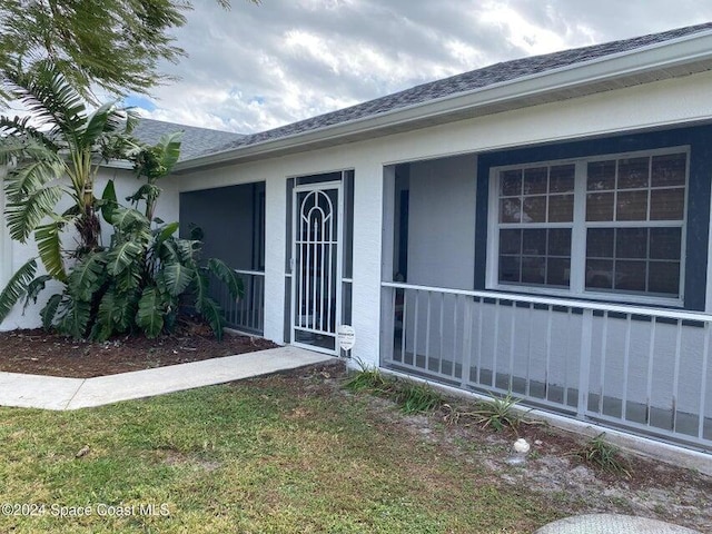 doorway to property featuring a yard