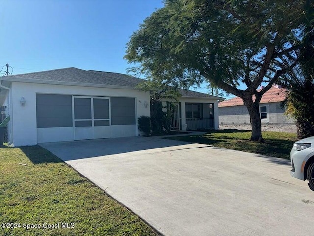 ranch-style home with a front yard and a garage