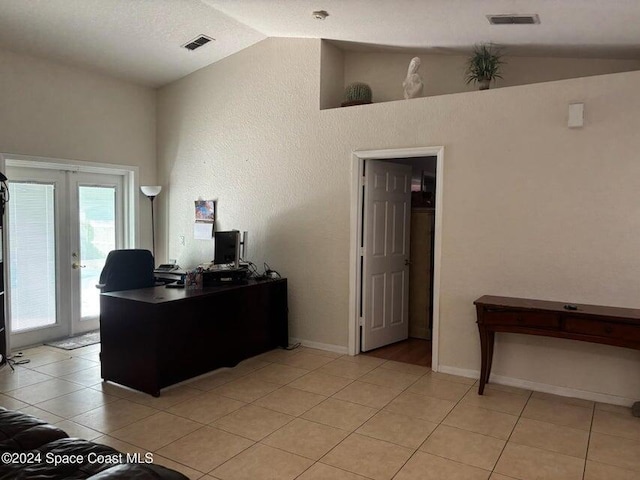 home office featuring french doors, light tile patterned flooring, and vaulted ceiling