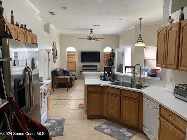 kitchen with stainless steel fridge, a textured ceiling, white dishwasher, sink, and light tile patterned flooring