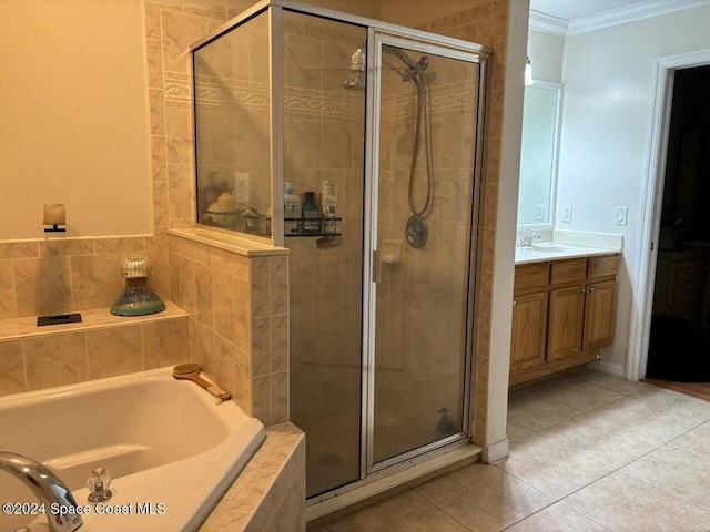 bathroom with tile patterned floors, vanity, ornamental molding, and shower with separate bathtub