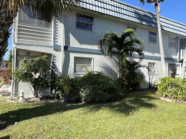 view of side of property with a yard