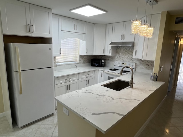 kitchen featuring kitchen peninsula, light stone countertops, white cabinets, and white appliances