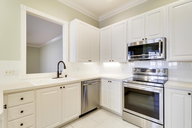 kitchen featuring appliances with stainless steel finishes, light tile patterned floors, white cabinetry, and sink