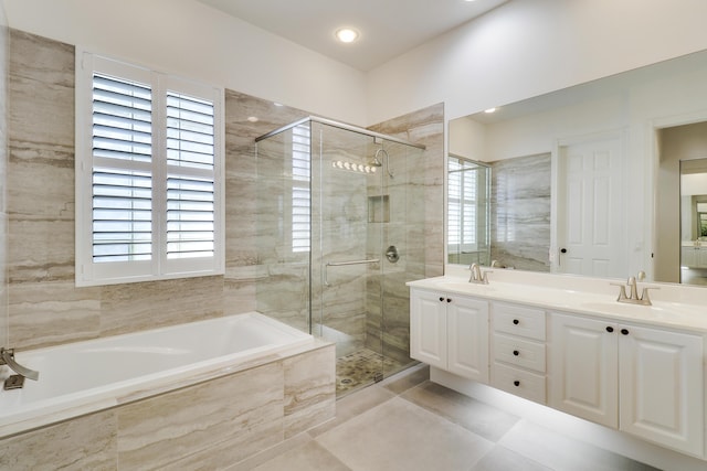 bathroom with vanity and independent shower and bath