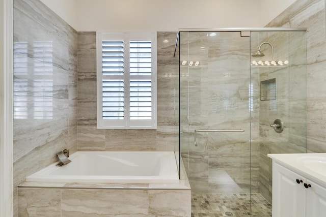 bathroom featuring separate shower and tub and vanity