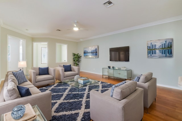 living room with crown molding, ceiling fan, and wood-type flooring