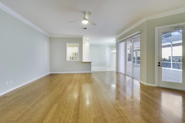 spare room featuring ceiling fan with notable chandelier, light wood-type flooring, and crown molding