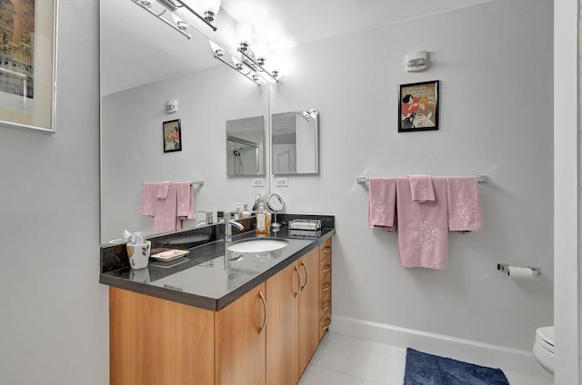 bathroom featuring tile patterned floors, vanity, and toilet