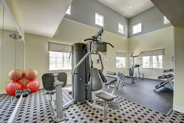 workout area featuring a towering ceiling