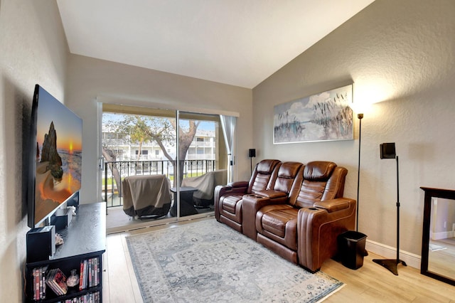 living room featuring vaulted ceiling and hardwood / wood-style flooring