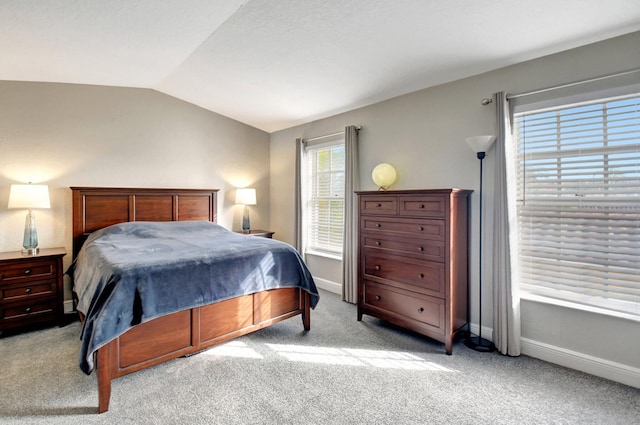 bedroom with lofted ceiling and light colored carpet