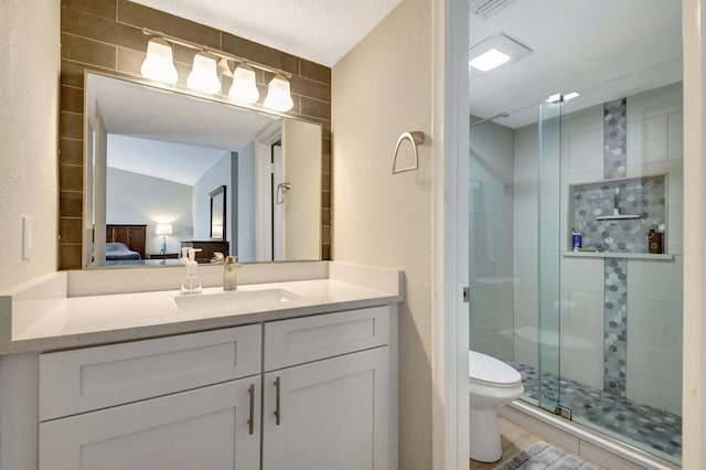 bathroom featuring toilet, vanity, an enclosed shower, and vaulted ceiling